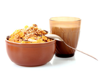 Bowl with muesli, milk and spoon isolated on white