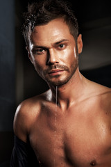 Fototapeta premium Portrait muscular guy having bath