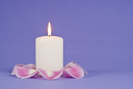 Single Candlelight And Pink Rose Pedals