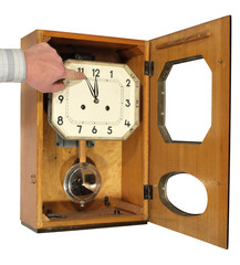 The hand bringing arrows of a wall clock, showing midnight.