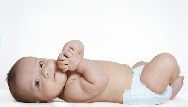 Baby Girl Laying On Back And Wearing A Diaper