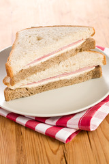 ham sandwich on checkered napkin