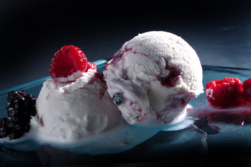 melting ice cream scoops with  berries