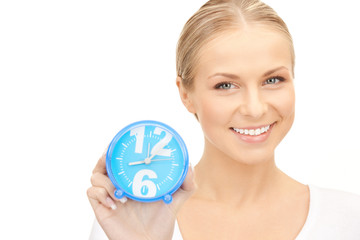 woman holding alarm clock