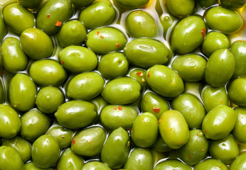 Green tasty olives background
