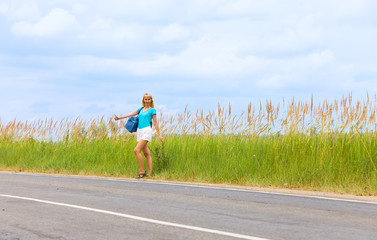 Hitchhiking girl votes on road