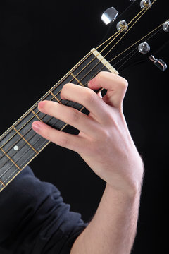 Human hand taking  C-major accord at guitar