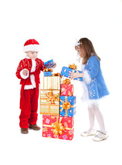 Little girl and boy in christmas clothes with toys