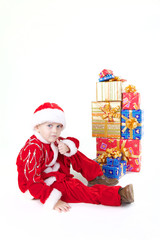 Boy in christmas clothes with presents