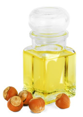 Лесной орех-фундук  на белом фоне и баночка с маслом