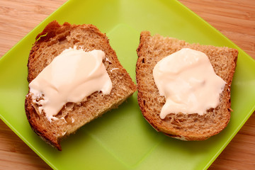 bread with butter in green plate
