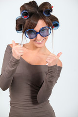 Young funny woman with hair-curlers