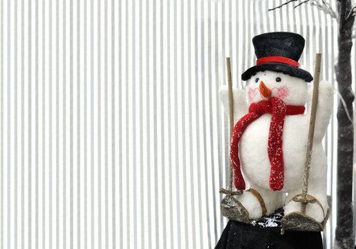 snowman with black hat on skis