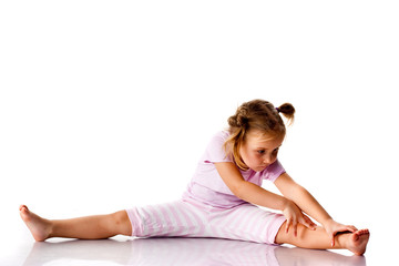 Obraz na płótnie Canvas Beautiful girl exercising, stretching