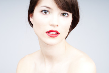 beautiful portrait of a young woman on light blue background