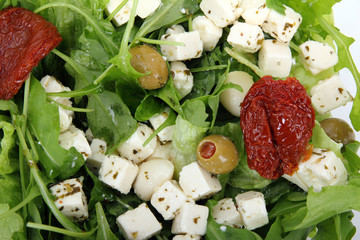 Fresh mix salad with dry tomato and feta with olives