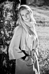 Young beautiful woman near birch