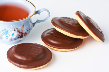 Cup of tea and chocolate iced cookies