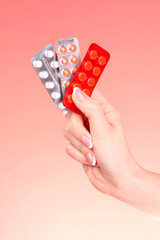 Women hands with tablets on red background