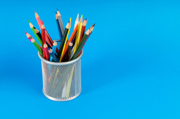 Many colorful pencils on the color background