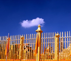 gold fence and blue sky