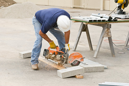 Worker Sawing Metal Studs