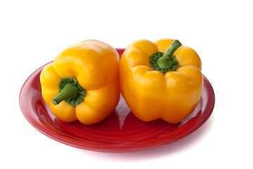 yellow paprikas  on the red  plate