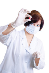 Doctor looking at red round pill