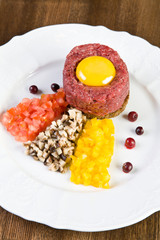 Raw chopped ostrich meat with vegetables