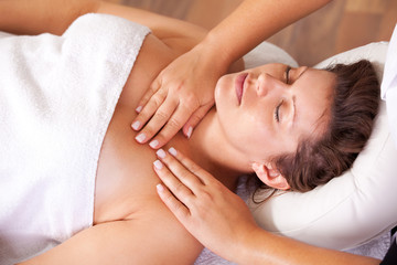 Young beautiful woman getting shoulders massage