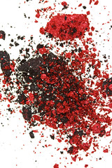 Red and black color crumbled eye shadows isolated on white