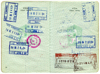 Visa entry and exit stamps in a passport