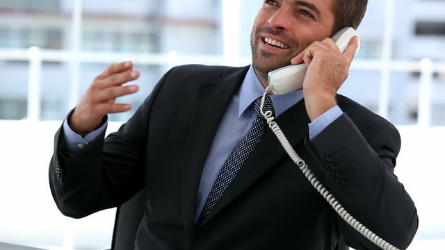 Portrait of a successful businessman on the phone in his office