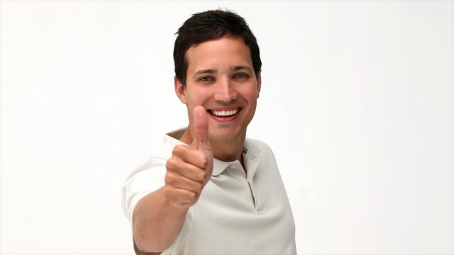Happy man doing a thumb up against a white background