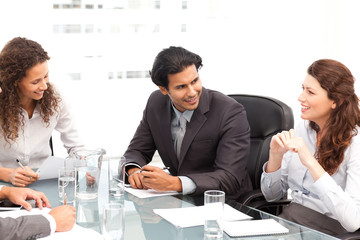 Businessman and businesswomen talking together around a table