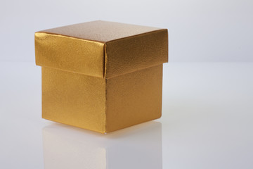 Golden gift box on white