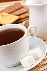 Breakfast: a cup of tea with a lump sugar and crackers