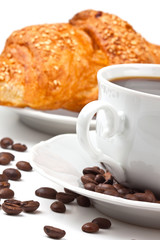 Breakfast: coffee and croissant with sesame seeds