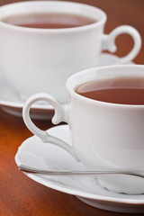 Two cups of tea with saucers