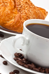 Breakfast: coffee and croissant with sesame seeds