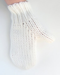 hand in a white woolen mitten