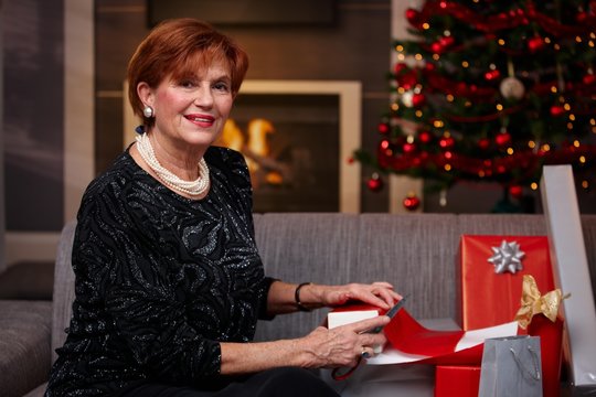 Senior woman wrapping christmas presents