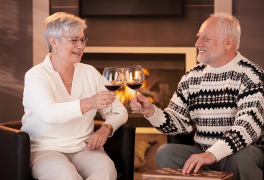 Retired husband and wife drinking wine together