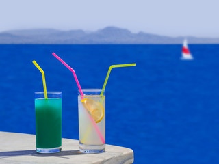Two cocktails on table at beach