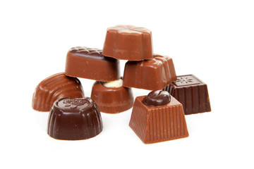 pile of chocolate bonbons over white background
