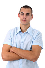 Fototapeta premium Young man in blue shirt with arms crossed isolated on white