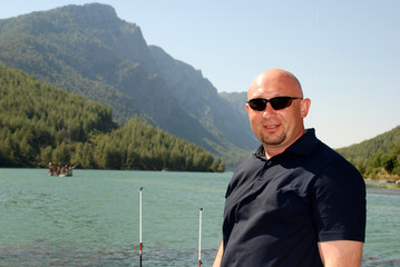 Fototapeta premium fisherman in sunglasses on the lake