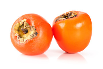 Ripe orange persimmons over white background