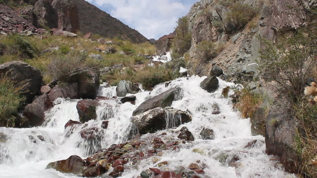 Water flows over a rock in the river.