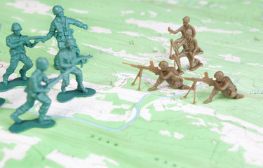 Plastic Army Men Fighting on Topographic Map Two Armies Battle